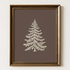 May include: A framed print displaying a cream-coloured illustration of a pine tree set against a dark brown backdrop. The artwork is presented within a gold-toned, rectangular frame, offering a classic and elegant appearance. Suitable for home decor.