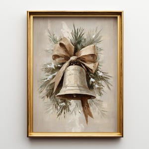 May include: A framed oil painting featuring a central metallic bell adorned with a large tan ribbon bow, surrounded by green pine branches with white accents, all set against a neutral beige background within a gold-colored rectangular frame.