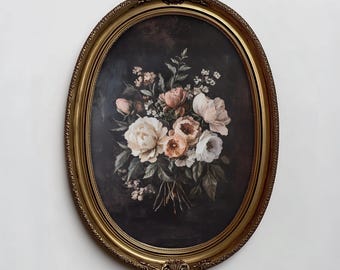 May include: An oval wall art piece featuring a floral bouquet of white, cream, and soft pink flowers with green leaves against a dark, moody background. The artwork is encased in an ornate, metallic gold frame with decorative detailing.