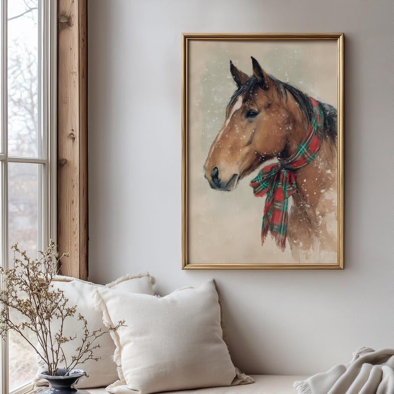Vintage style horse wearing a red and green tartan bow with snow falling on a beige background, rustic printable farmhouse Christmas wall art.