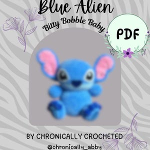May include: A digital PDF pattern titled Blue Alien Bitty Bobble Baby by Chronically Crocheted @chronically_abby, featuring a blurry blue and pink crocheted alien plush toy with large ears, centered on a gray background with floral accents.