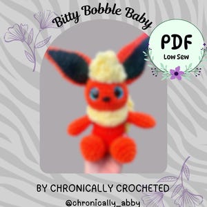 May include: A crochet plush toy resembling a fox-like creature with orange fur, a cream-colored chest and head tuft, and large dark ears. The text reads: flare Monster, Bitty Bobble Baby, PDF, Low Sew, BY CHRONICALLY CROCHETED, @chronically_abby.