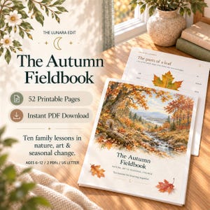 A printed Autumn Fieldbook cover and leaf study page displayed on a wooden desk next to fallen autumn leaves.