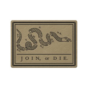 May include: A rectangular tan sign featuring a black line drawing of a segmented snake with the letters S.C., N.C., V., M., P., N.J., N.Y., and N.E. placed near the segments. The text JOIN, or DIE. is printed in black below the snake.