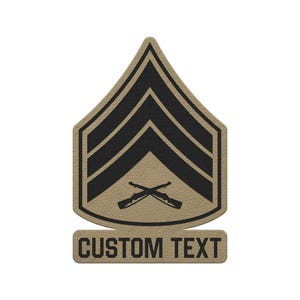 May include: A tan patch featuring a black military-style chevron rank insignia with three stripes and two crossed rifles centered below. Below the main shield-shaped emblem is a rectangular tab with the black text CUSTOM TEXT printed on it.