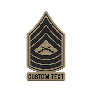 May include: A tan and black military-style rank patch featuring a chevron design with three stripes above and three stripes below a central emblem of two crossed rifles. Below the main chevron shape is a rectangular tab with the text CUSTOM TEXT.