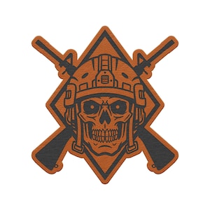 May include: A patch featuring a dark gray skull wearing a tactical helmet, centered over a diamond shape and two crossed rifles. The design uses a burnt orange and dark gray color scheme with a textured surface finish throughout the graphic.