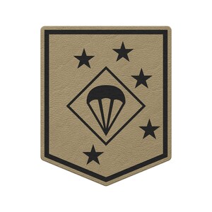 May include: Tan and black patch with a black border. The patch features four black stars and a black diamond containing a parachute symbol. The patch has a textured appearance.