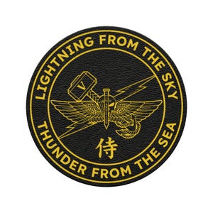 May include: A round, black patch with gold lettering and a central emblem. The text reads "LIGHTNING FROM THE SKY" and "THUNDER FROM THE SEA". The emblem features a winged design, a sword, and a hammer.