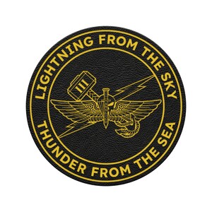 May include: A round, black patch with gold lettering and a central emblem. The text reads "LIGHTNING FROM THE SKY" and "THUNDER FROM THE SEA". The emblem features a winged design with a sword, hammer, and lightning bolt.