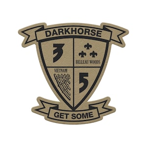 May include: Tan and black patch with the text "DARKHORSE" at the top. The patch is shield-shaped, with the numbers "3" and "5" on either side. The words "VIETNAM" and "BELLEAU WOODS" are also present, along with the phrase "GET SOME".