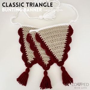 May include: A crochet bunting banner with three triangular flags. The flags are beige with a red scalloped edge and red tassels. The banner is made with white yarn.