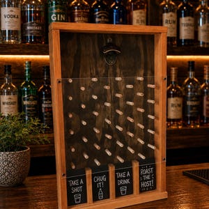 May include: A wooden wall-mounted game board with a dark stained back panel, a clear acrylic front, and a metal bottle opener at the top. It features rows of wooden pegs and four bottom slots labeled: TAKE A SHOT, CHUG IT!, TAKE A DRINK, and ROAST THE HOST!