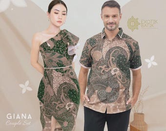 May include: A couple wearing matching batik outfits. The woman wears a green and brown one-shoulder dress with a ruffle detail. The man wears a short-sleeved button-up shirt in a similar pattern. The outfits are part of the "GIANA Couple Set".