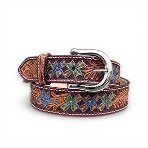 May include: A brown leather belt with a silver buckle. The belt features a floral design with blue, green, and orange accents. The edges are stitched with white thread. The belt is approximately 1.5 inches wide.