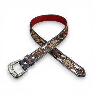 May include: Black leather belt with floral and leaf tooling, turquoise accents, and a silver buckle. The belt features a red leather interior and is adorned with small metal studs. A stylish western accessory.