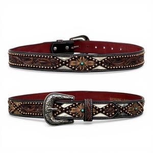 May include: Two leather belts with intricate tooling and decorative metal studs. The belts feature a mix of brown, white, and turquoise accents. One belt has a silver buckle, and the other has a simple black buckle.