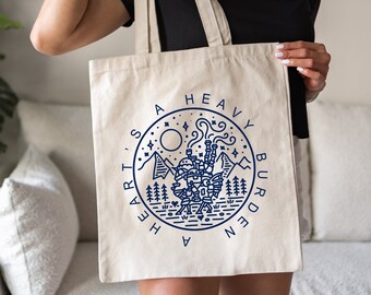 Bolso de mano inspirado en "El castillo ambulante" con la frase "Un corazón es una carga pesada".