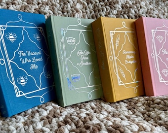 May include: Four hardcover books in blue, sage green, mustard yellow, and pink. Each cover features a silver foil frame with unique icons and titles: The Viscount Who Loved Me, An Offer From a Gentleman, Romancing Mister Bridgerton, and The Duke and I.