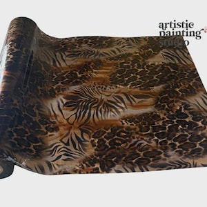 May include: A roll of decorative paper with a glossy finish, featuring a brown and tan animal print design. The pattern combines zebra stripes and leopard spots. The text "artistic painting studio" is visible in the upper right corner.