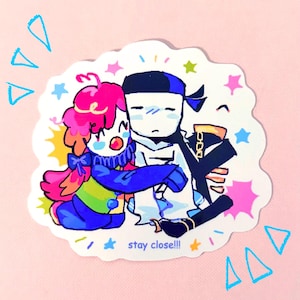 May include: A sticker featuring two cartoon figures embracing. One figure has pink hair and a blue bow, the other is white with a blue headband. The sticker has the text "stay close!!!" and is surrounded by stars and triangles.