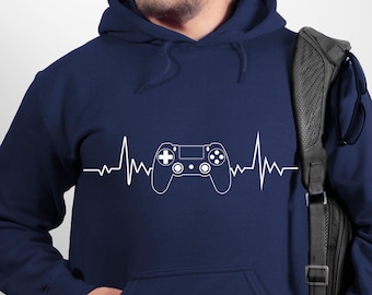 May include: A navy blue hoodie with a white graphic of a video game controller and a heartbeat line. The hoodie has a kangaroo pocket and a drawstring hood.