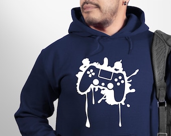May include: A navy blue hoodie with a white graphic of a video game controller with paint splatters.