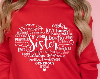 May include: Red sweatshirt with a white heart-shaped design that says "By your side... Sister" and lists positive attributes of a sister, such as caring, honest, supportive, kind, best friend, thoughtful, amazing, and special.