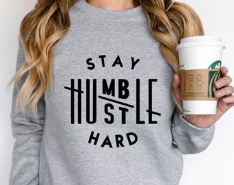 May include: Gray sweatshirt with black text that reads "Stay Humble Hustle Hard".