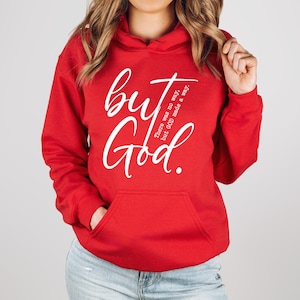 May include: A red hooded sweatshirt with a front pocket and white text that reads "but God." Additional text on the right side of the graphic reads "There was no way, but GOD made a way."