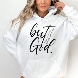 May include: White hooded sweatshirt with a front pocket and the words "but God" in black script. The phrase "There was no way, but GOD made a way" is printed vertically on the right side of the design.