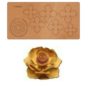 May include: A die-cut template for crafting a paper flower. The template includes multiple flower petal shapes and a spiral for the center of the flower. The template is made of brown wood and has the code YY8043 printed on it. A finished paper flower is shown below the template.