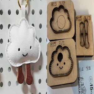 Puede incluir: Un llavero de cuero blanco en forma de nube con patas de cuero marrón y una cara sonriente. El llavero se muestra junto a tres punzones de cuero de madera, etiquetados como 815 3/1, 815 3/2 y 815 3/3.