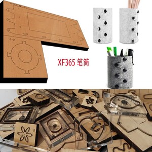 Puede incluir: Un conjunto de formas troqueladas para manualidades, que incluyen una flor, un corazón y varias formas geométricas. Las formas son de plástico transparente y están dispuestas sobre una superficie de madera. El texto "XF365" es visible en rojo sobre la superficie de madera.