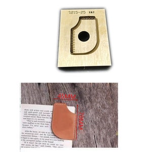 May include: A leather craft cutting die with a rounded shape and a hole in the center. The die is made of wood and is 4.5 inches by 7 inches. The die is used to cut leather for projects such as wallets, belts, and bags.
