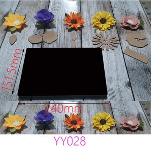 May include: A set of 10 felt flower craft supplies, including 6 flowers, 3 leaves, and 1 stem. The flowers are in shades of yellow, orange, purple, and pink. The flowers are 240 mm wide and 151.5 mm tall. YY028