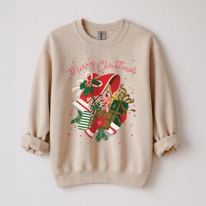 Close‑up of DTG print showing crisp lines on vintage holiday graphic and soft fleece texture.