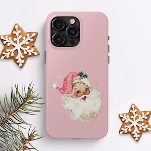 May include: Pink phone case with a vintage illustration of Santa Claus's face. The illustration is in a retro style with a pink hat and white beard.