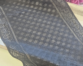 May include: A black lace trim featuring a central panel of repeating small triangular patterns flanked by two distinct borders. Each border displays a series of interconnected diamond shapes outlined in a fine, delicate mesh fabric.