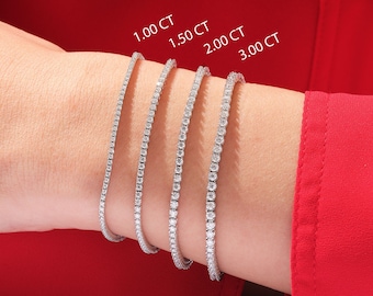 May include: Four diamond tennis bracelets in different sizes, 1.00 CT, 1.50 CT, 2.00 CT, and 3.00 CT, on a person's wrist.