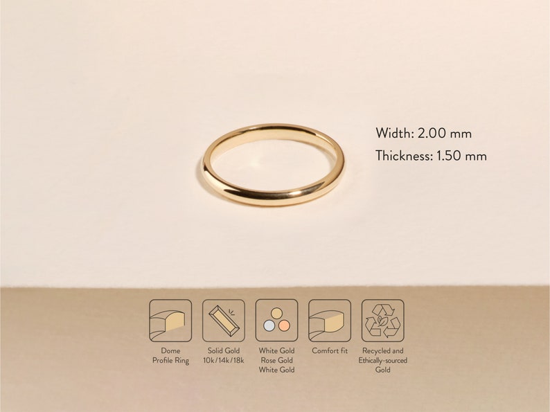 May include: A 2.00 mm wide, 1.50 mm thick, gold dome profile ring. The ring is made of solid gold in 10k, 14k, or 18k. It is available in white gold, rose gold, or white gold. The ring has a comfort fit and is made with recycled and ethically sourced gold.