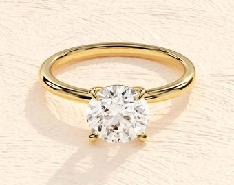 May include: A gold engagement ring with a large oval-shaped diamond.