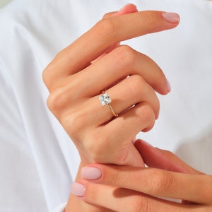 May include: A gold ring with a square-shaped diamond.