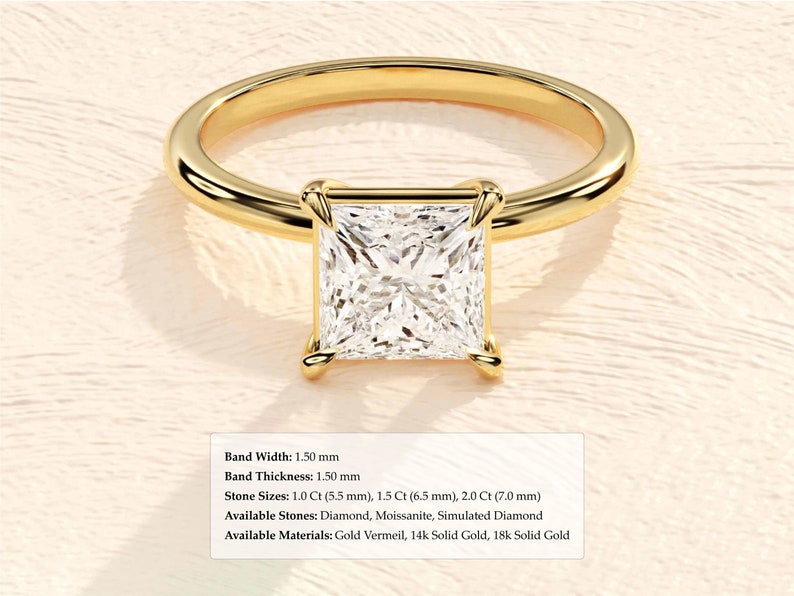 May include: A gold engagement ring with a square-shaped diamond. The band is 1.50 mm wide and 1.50 mm thick. The diamond is available in sizes of 1.0 ct (5.5 mm), 1.5 ct (6.5 mm), and 2.0 ct (7.0 mm). The ring is available in gold vermeil, 14k solid gold, and 18k solid gold.