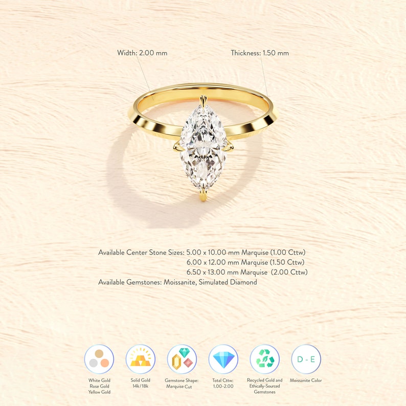 May include: A gold ring with a marquise cut diamond. The ring is available in white, rose, or yellow gold. The diamond is available in sizes ranging from 5.00 x 10.00 mm to 6.50 x 13.00 mm. The ring is also available with a moissanite or simulated diamond.