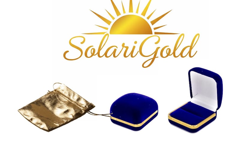 May include: The image displays a gold drawstring pouch, a closed blue velvet jewelry box with gold trim, and an open blue velvet jewelry box with gold trim. The logo "SolariGold" is at the top.