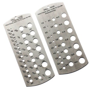 May include: Two metal drill gauge tools with fractional size markings. The tool on the left has markings from 1/16 to 1/2 inch by 64ths. The tool on the right has markings from 1.0 mm to 13.0 mm.