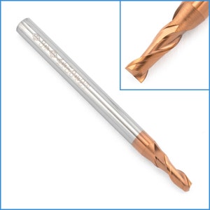 May include: A close-up of a gold-colored end mill with a silver shank. The end mill has a spiral flute design and is used for cutting metal.