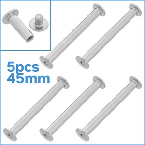 May include: Five silver-toned, 45mm long, threaded, round-headed,  screws with a flat head.  The screws are arranged in a diagonal pattern.