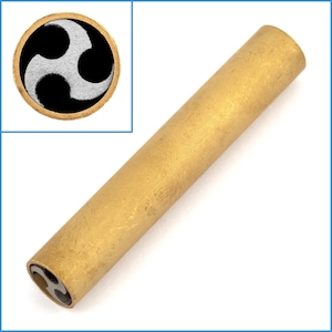 May include: A gold-colored metal tube with a black and white triquetra symbol on the end.